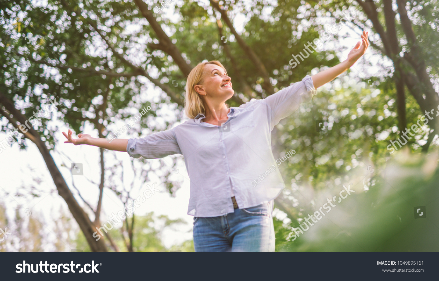 stock-photo-happy-woman-in-spring-or-summer-forest-park-open-arms-with-happiness-hope-and-vitality-caucasian-1049895161.jpg