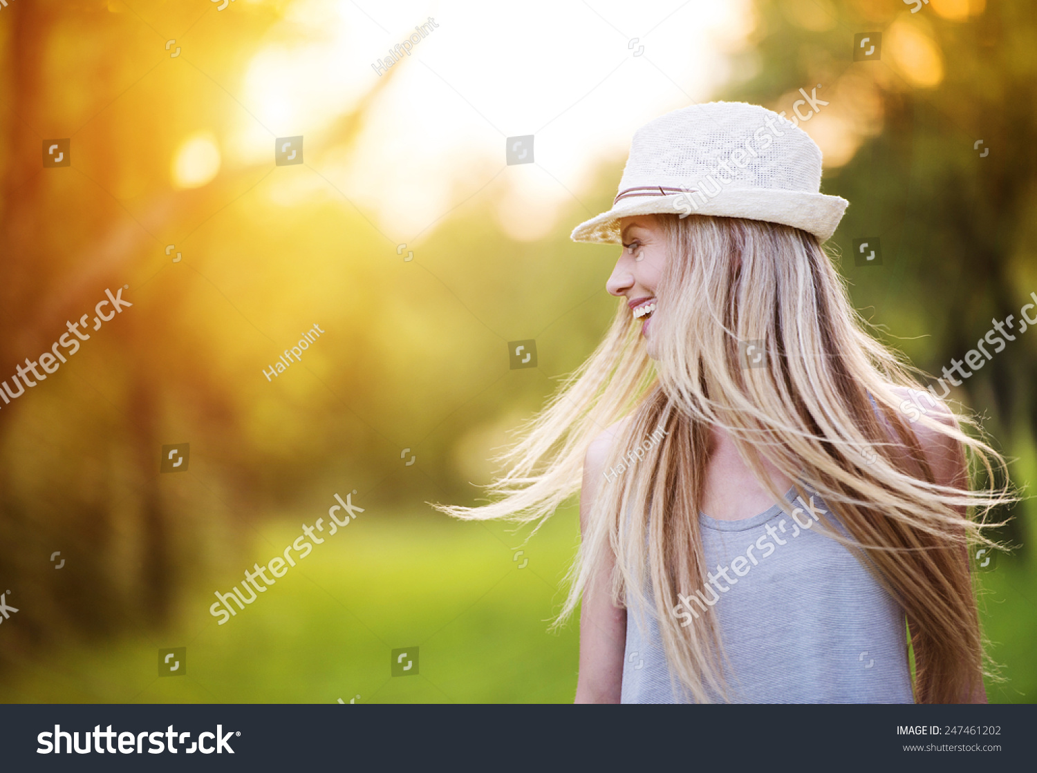 stock-photo-attractive-young-woman-enjoying-her-time-outside-in-park-with-sunset-in-background-247461202.jpg